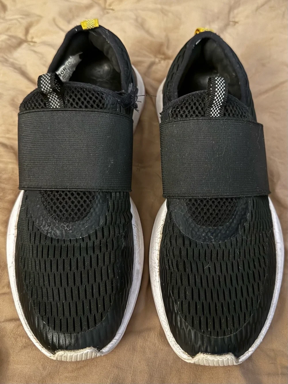 Sorel Black Slip-On Athletic Sneakers with White Soles and Yellow Heel Tab